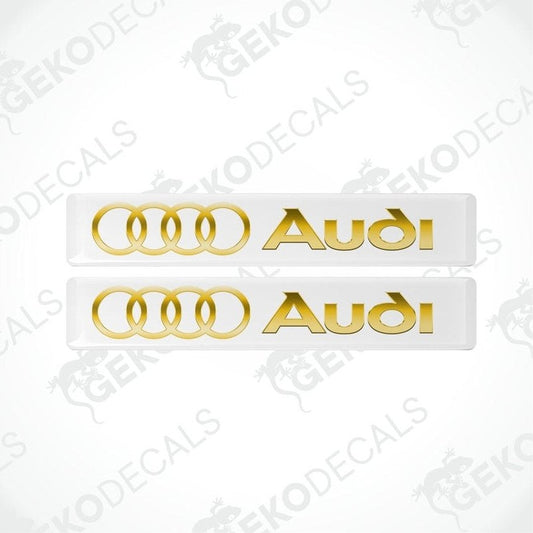 Two gold Audi decals on a white background with 'Gekodecals' branding.