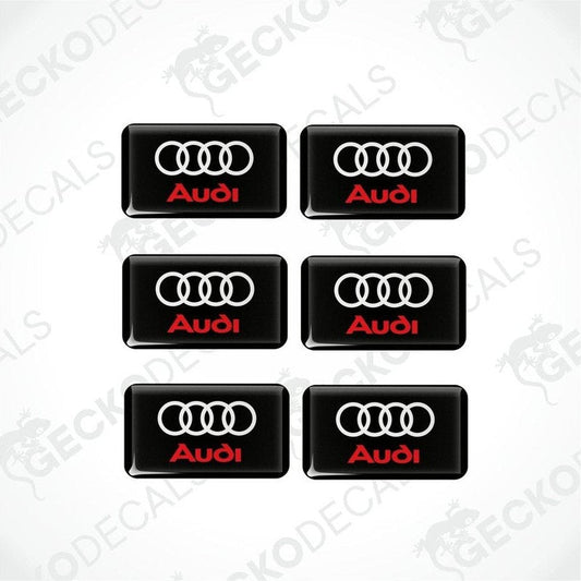 A set of six black vinyl stickers with a red and white Audi logo on each.
