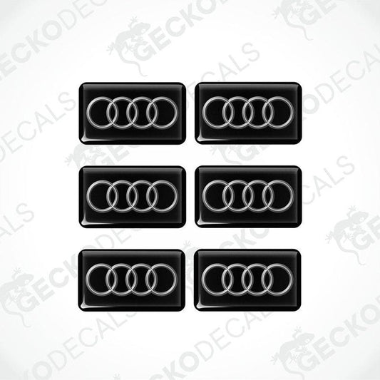 A set of six black and white vinyl decals with the Audi logo.