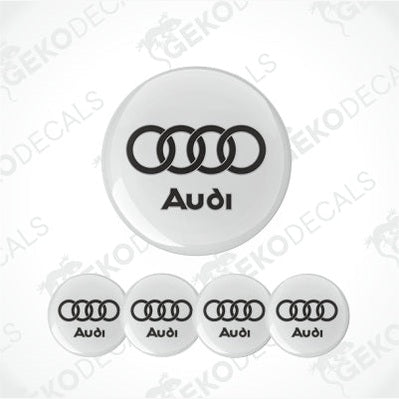 A set of five white round car epoxy decals with the Audi logo in black.