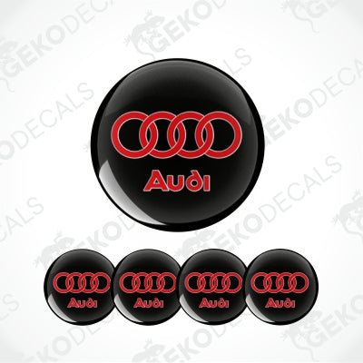 Set of four black, red, and white Audi branded vinyl decals, intended for use as car wheel caps or stickers.
