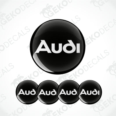 A set of black round car epoxy decals with the Audi logo in white.