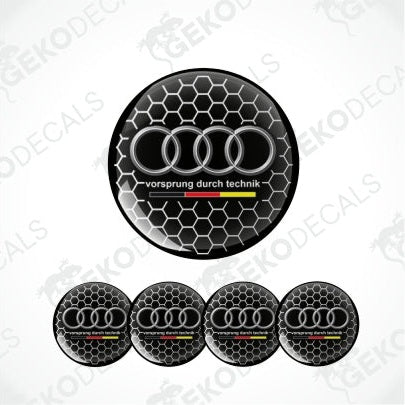 A set of four black and silver Audi wheel decals with a honeycomb pattern and the 'Vorsprung durch technik' slogan.