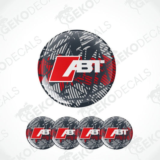 A set of four round vinyl stickers with a geometric red, grey, black pattern and the ABT brand logo in the center.