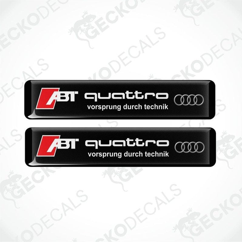 Two black vinyl stickers with the text 'ABT QUATTRO' and the Audi logo, with the slogan 'VORSPRUNG DURCH TECHNIK'.