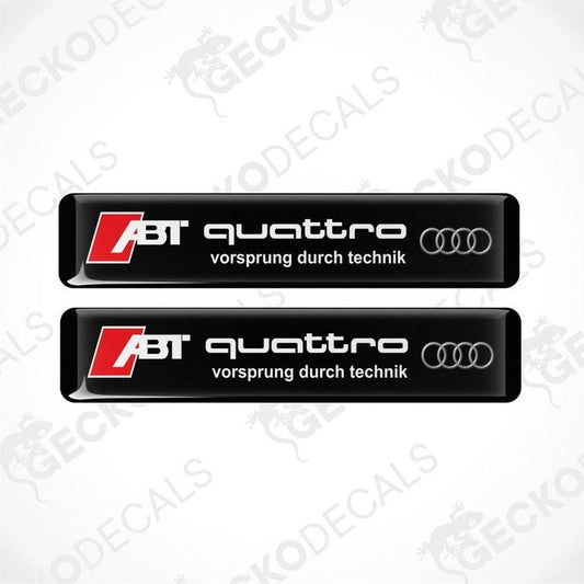 Two black vinyl stickers with the text 'ABT QUATTRO' and the Audi logo, with the slogan 'VORSPRUNG DURCH TECHNIK'.