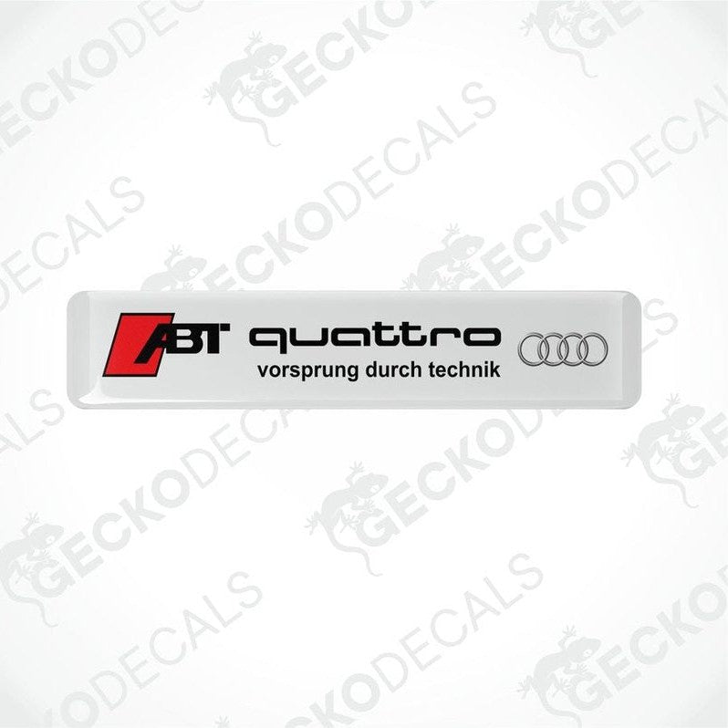  White vinyl stickers with the text 'ABT QUATTRO' and the Audi logo, with the slogan 'VORSPRUNG DURCH TECHNIK'.