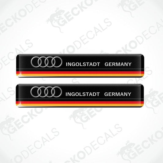 Two black vinyl stickers with red and yellow accents and the text 'INGOLSTADT GERMANY' along with the Audi brand logo.