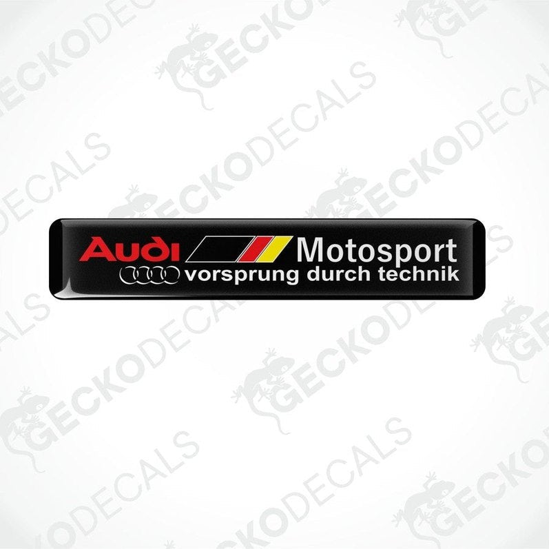 Black vinyl stickers with red, white, and yellow Audi Motosport branding, placed on a white background.