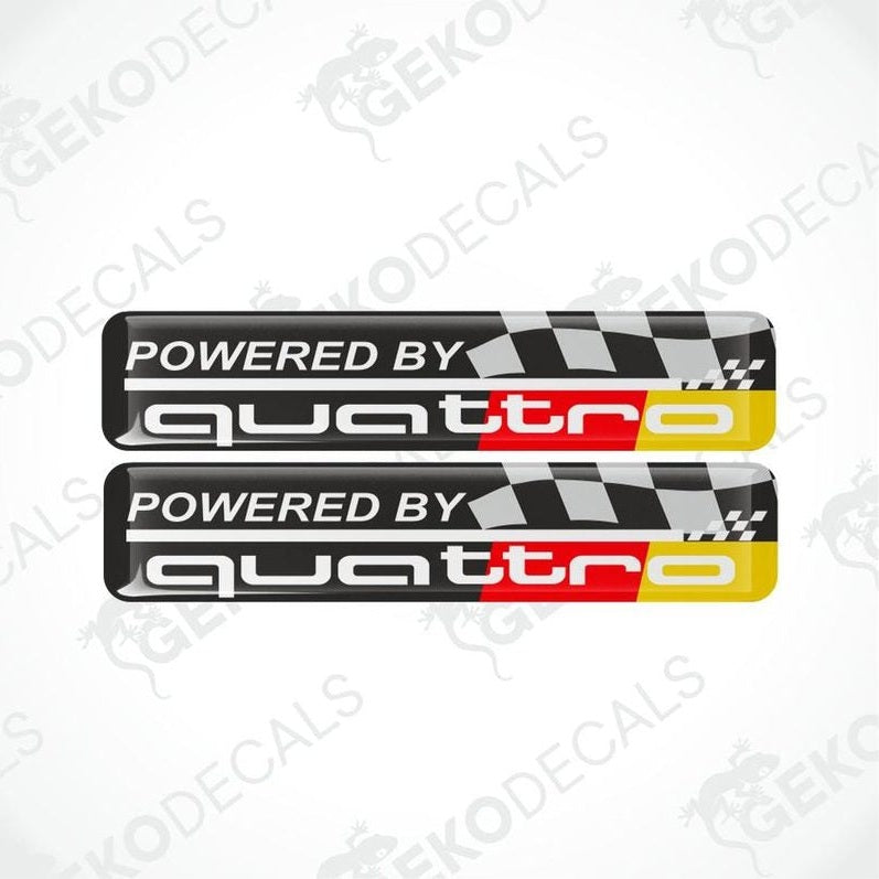 Two 'Powered by quattro' decals with a checkered pattern on a white background.