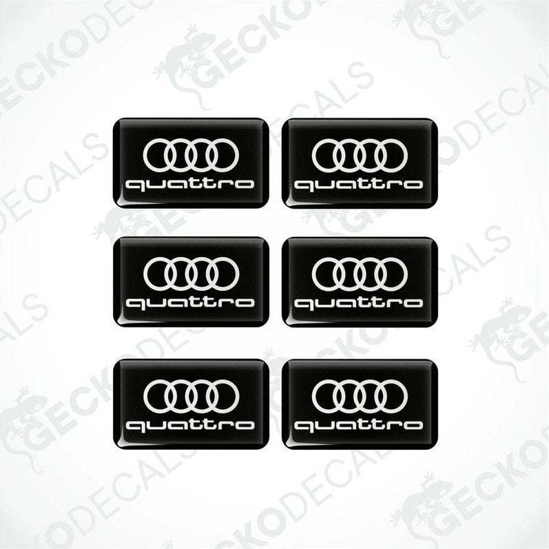 A set of black vinyl decals with the 'quattro' logo printed in white.