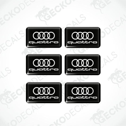 A set of black vinyl decals with the 'quattro' logo printed in white.