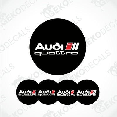 Audi lettering with quattro underneath on a black round background