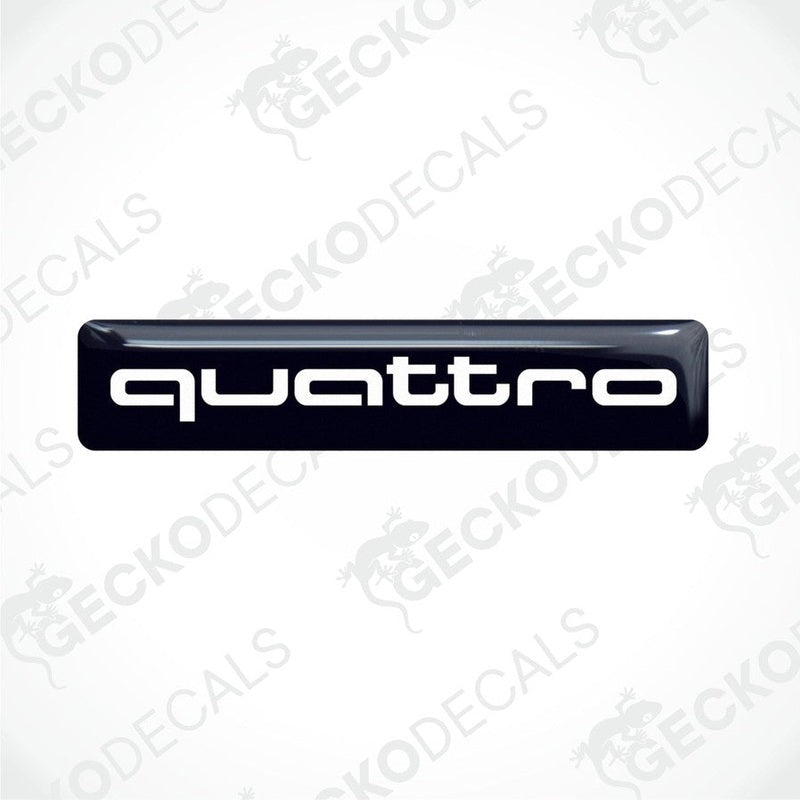 Black vinyl stickers with the word 'QUATTRO' written in white, placed against a white background.