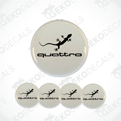 A set of four white vinyl stickers with a black 'QUATTRO' logo and a design of a lizard, presented on a clear background.