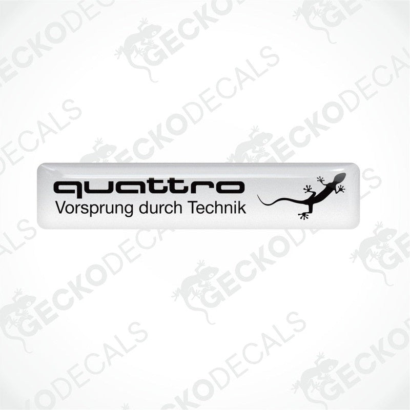  White vinyl decals with 'quattro Vorsprung durch Technik' and a black Audi logo on a white background.
