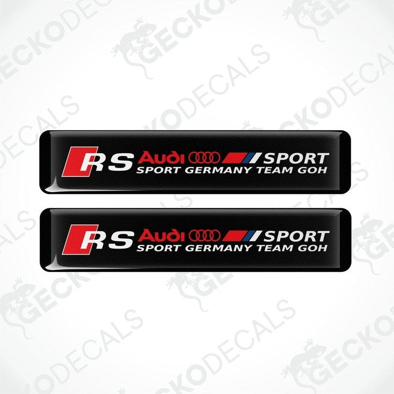 Two black rectangular car decals with red and white text and logos, representing Audi RS Sport Germany Team GOH.