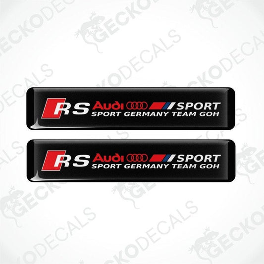 Two black rectangular car decals with red and white text and logos, representing Audi RS Sport Germany Team GOH.