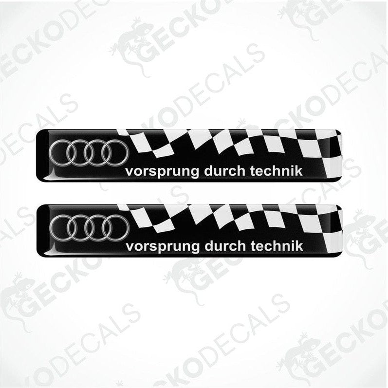 Two black and white vinyl decals with 'vorsprung durch technik' text and Audi logo