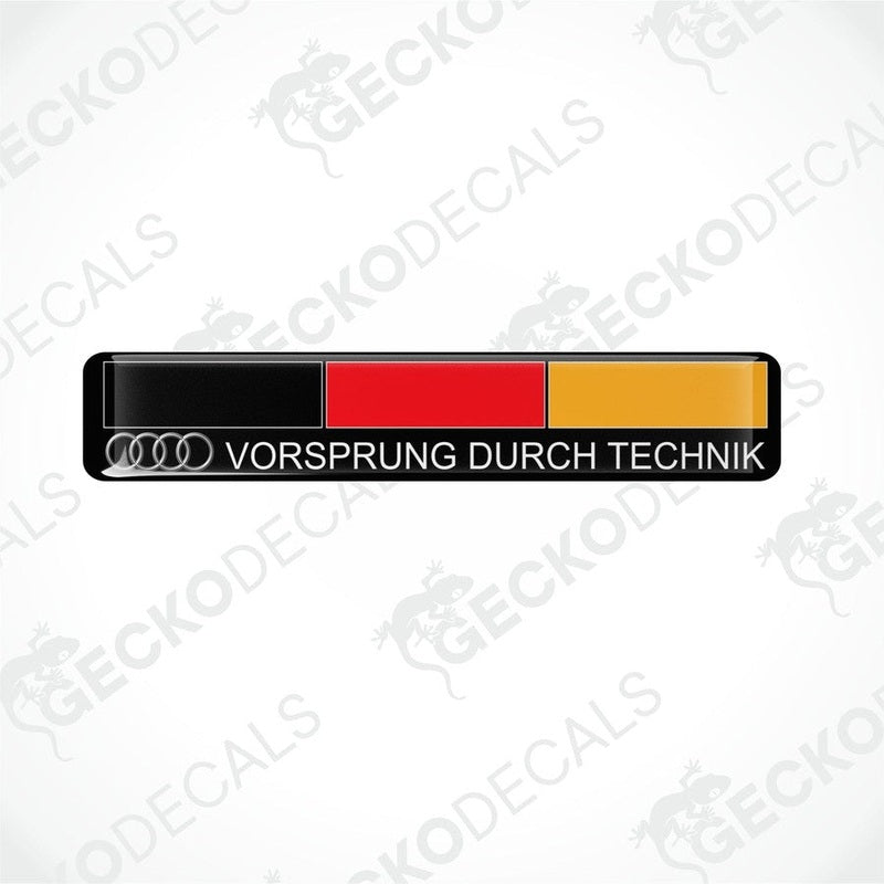 Rectangular car decals with 'VORSprung DURCH TECHnik' text and the Audi logo, predominantly black with red and yellow stripes.