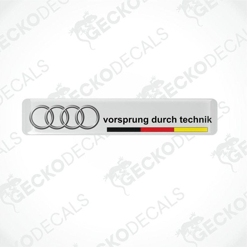 White vinyl decals with the text 'vorsprung durch technik' and the Audi logo in silver, arranged horizontally.