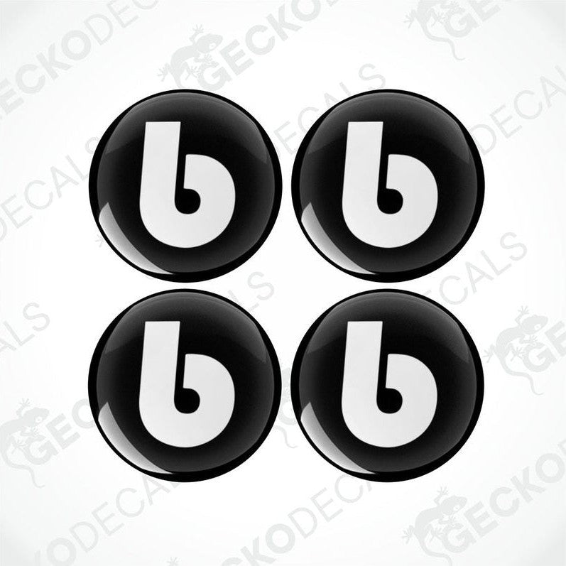 A set of four black and white vinyl decals with the letter 'b' on them, designed for use on vehicles.