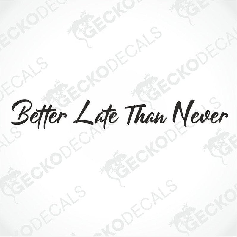 A die cut decal with the phrase 'Better Late Than Never' displayed on the front windscreen of a gray truck.