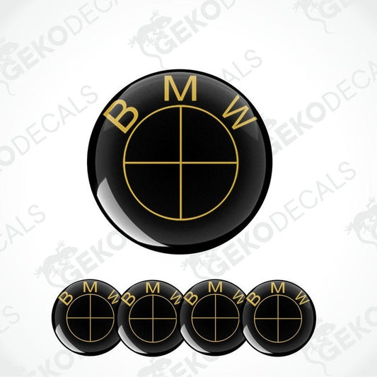A set of four black and gold BMW vinyl decals with a geometric pattern.