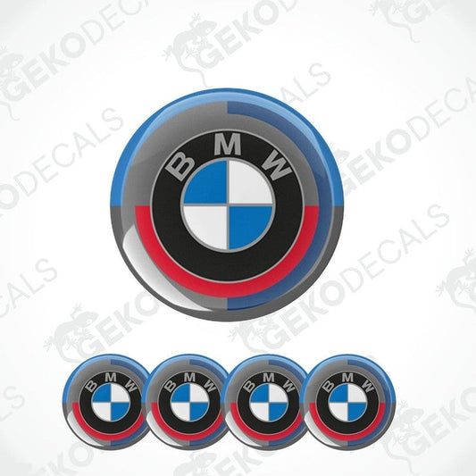 A set of four BMW branded vinyl stickers with a geometric design, featuring black, blue, and red colors.