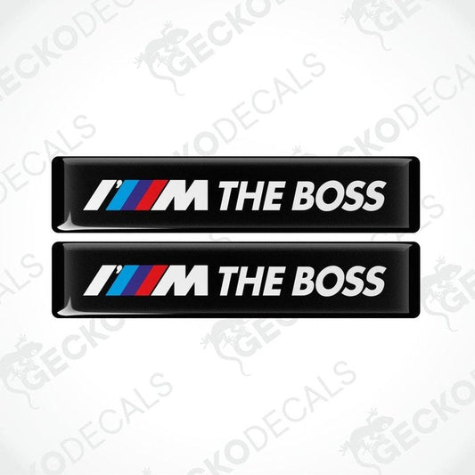 Two black rectangular car decals with the text 'THE BOSS' and the BMW logo in white, red, and blue.