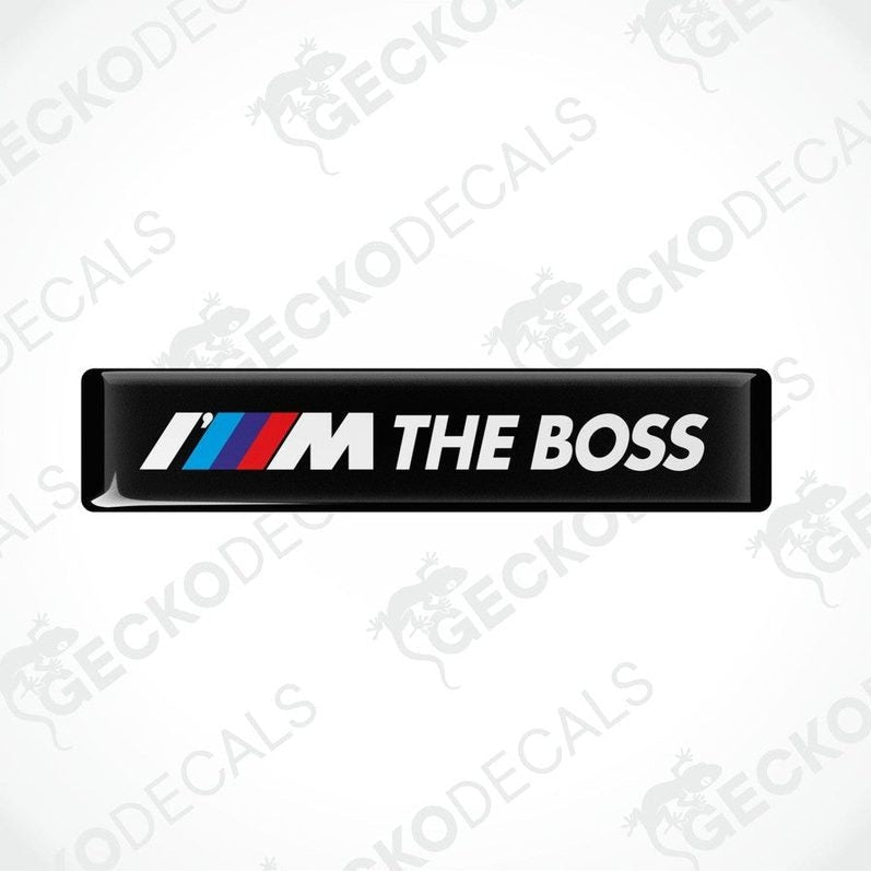 black rectangular car decals with the text 'THE BOSS' and the BMW logo in white, red, and blue.