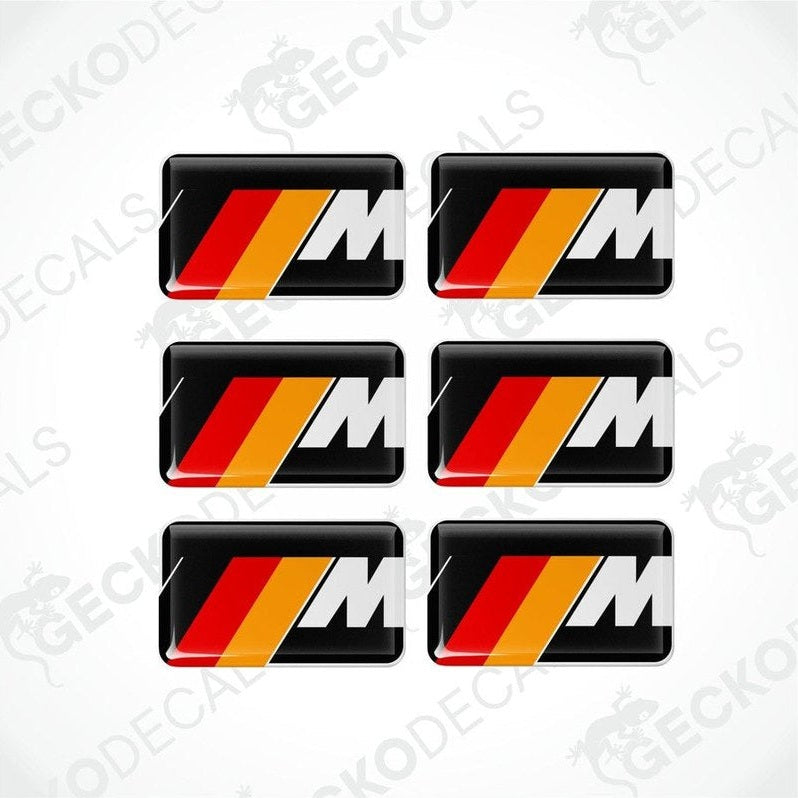Set of six white BMW M branded polyurethane-coated vinyl stickers on a black background.