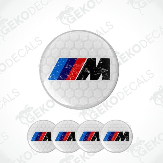 A set of four vinyl decals with polyurethane coating featuring the BMW M logo in WHITE, red, and blue on a honeycomb pattern background.