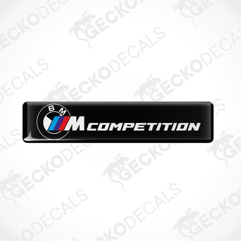 Black rectangular car decals with 'BMW COMPETITION' text and the BMW logo in white and red.