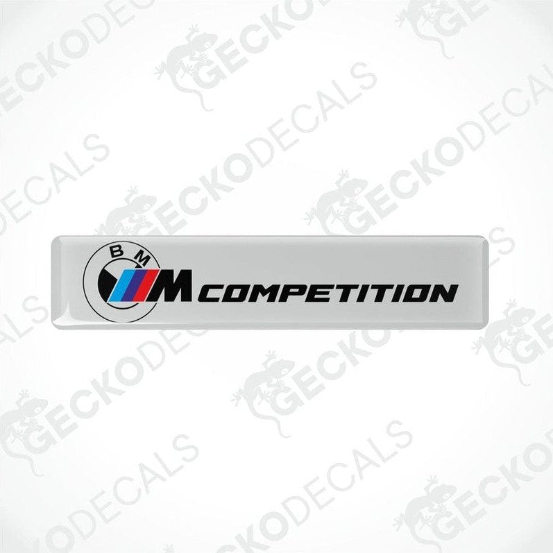 White rectangular car decals with 'BMW COMPETITION' text and the BMW logo in black and red.