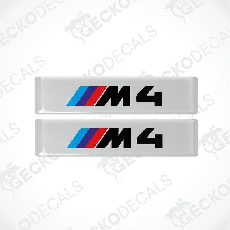 Two stickers with BMW M4 logos in light blue, blue and red on a white background