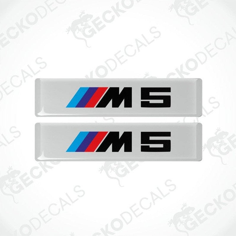 Two stickers with BMW M5 logos in light blue, blue and red on a white background