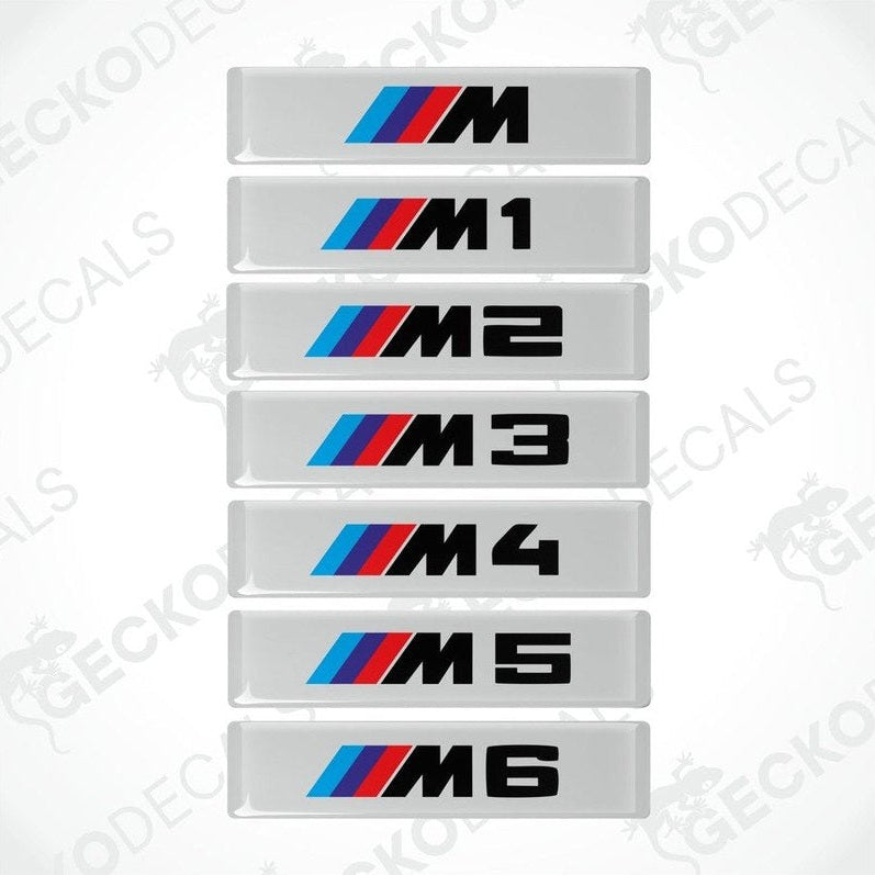 A series of white decals with black and colored text representing different BMW M series models from M1 to M6.
