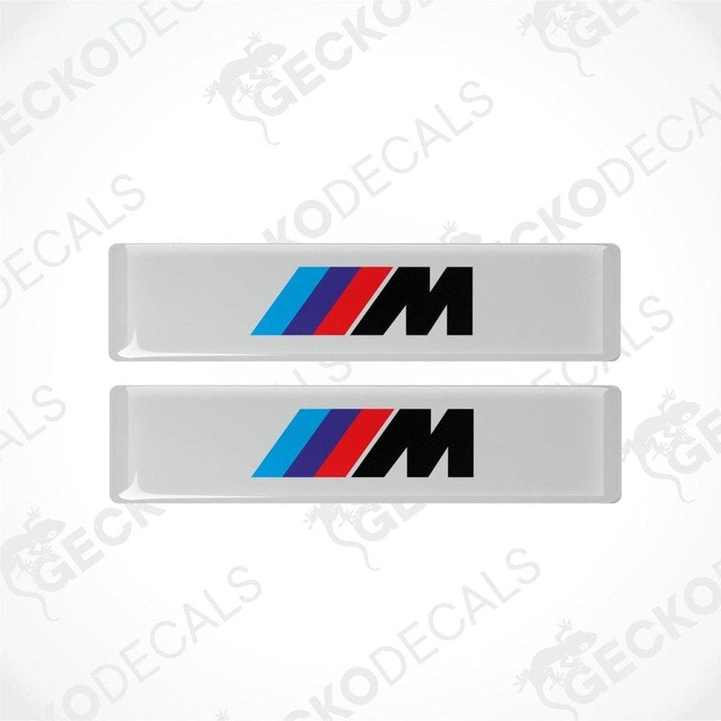 Two stickers with BMW M logos in light blue, blue and red on a white background