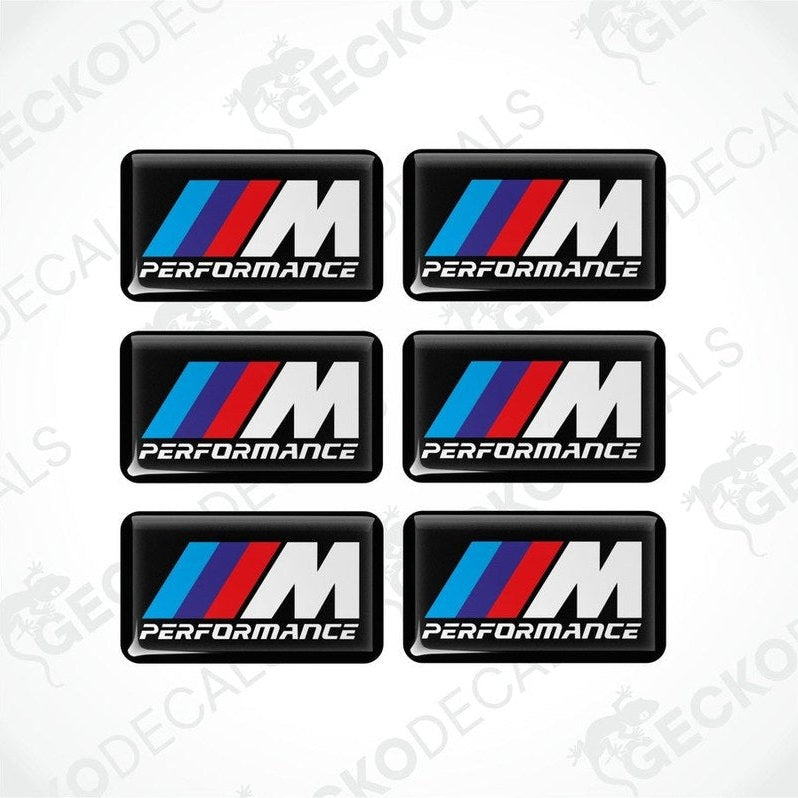 Set of six BMW M Performance vinyl stickers with polyurethane coating featuring the M Performance logo in white, red and blue on a black background.