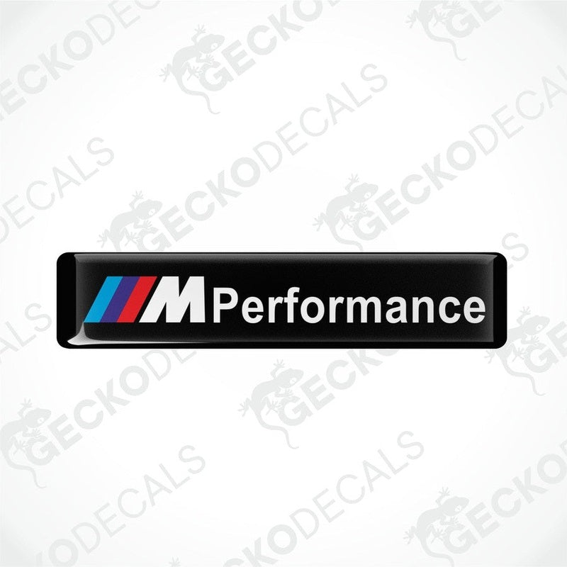 Rectangular black vinyl decals with 'M Performance' text and the BMW logo in red, blue, and white.