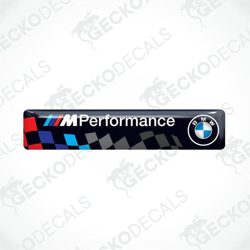 Vinyl stickers with a BMW M PERFORMANCE logo, predominantly black with blue and red checkered pattern.