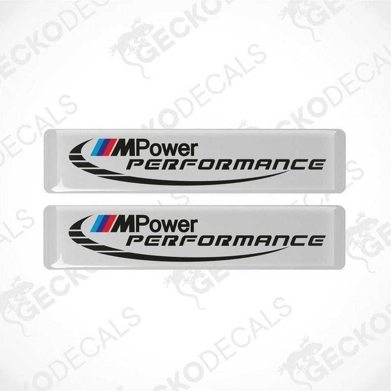 Two white decals with 'M Power Performance' text and the BMW logo in black and blue