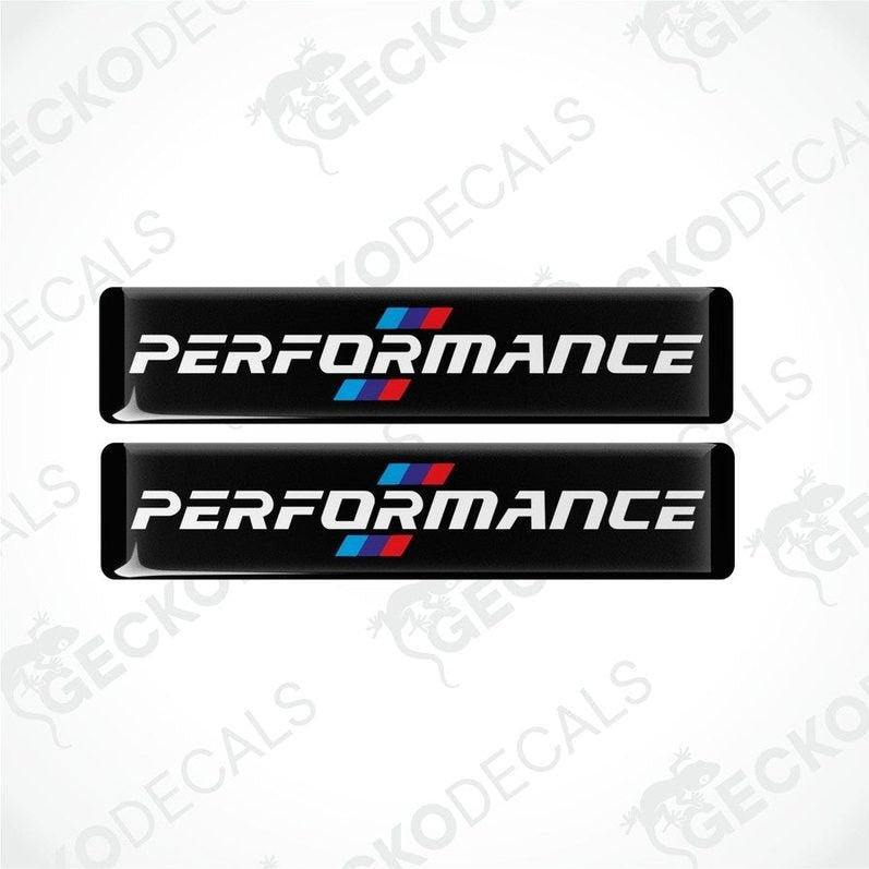 Set of four black vinyl decals with 'PERFORMANCE' text and a red and blue emblem, indicative of BMW branding.