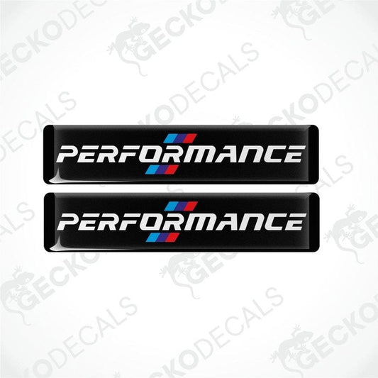 Set of four black vinyl decals with 'PERFORMANCE' text and a red and blue emblem, indicative of BMW branding.