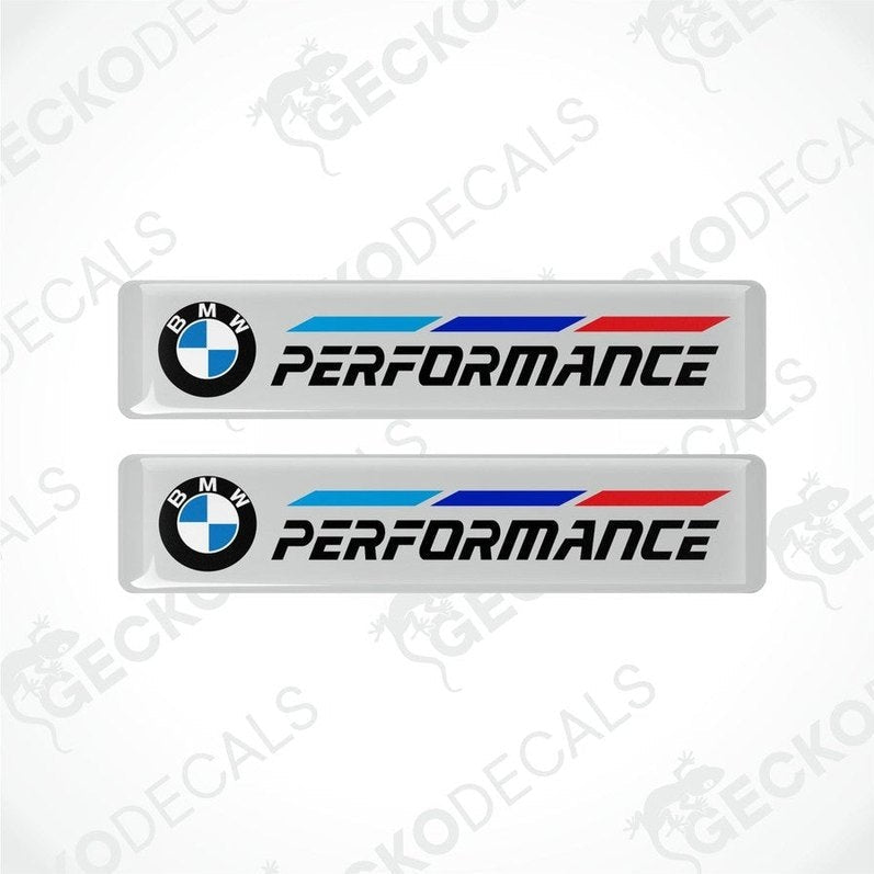 A set of two BMW Performance vinyl decals with blue and red stripes on a white background.