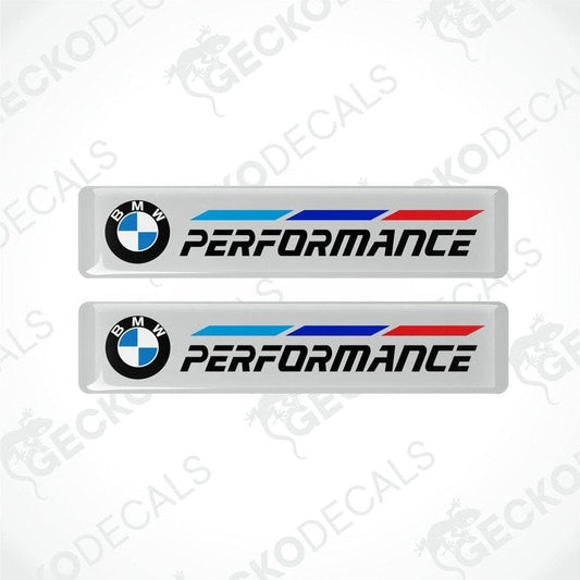 A set of two BMW Performance vinyl decals with blue and red stripes on a white background.
