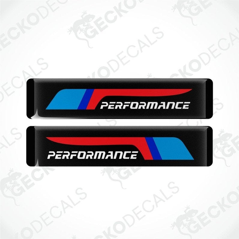 Two black vinyl stickers with red and blue geometric patterns and the text 'PERFORMANCE' on a white background.