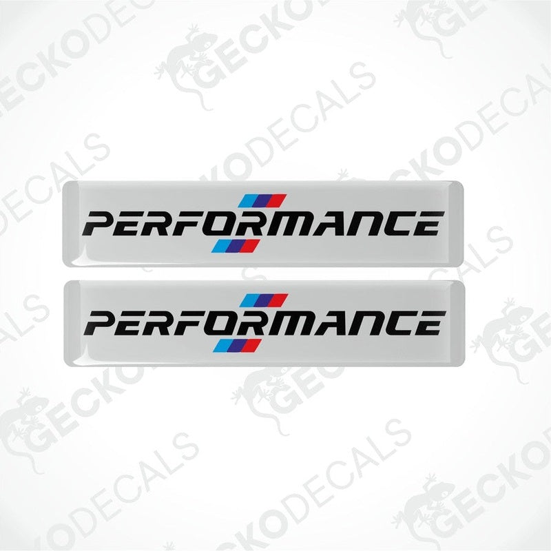 Set of four white vinyl decals with 'PERFORMANCE' text and a red and blue emblem, indicative of BMW branding.
