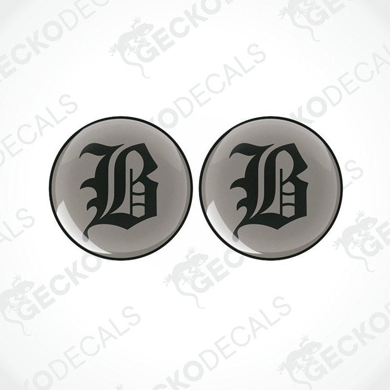 Two round black vinyl stickers with a large white 'B' in the center, placed against a white background with the text 'GECKODECALS'.
